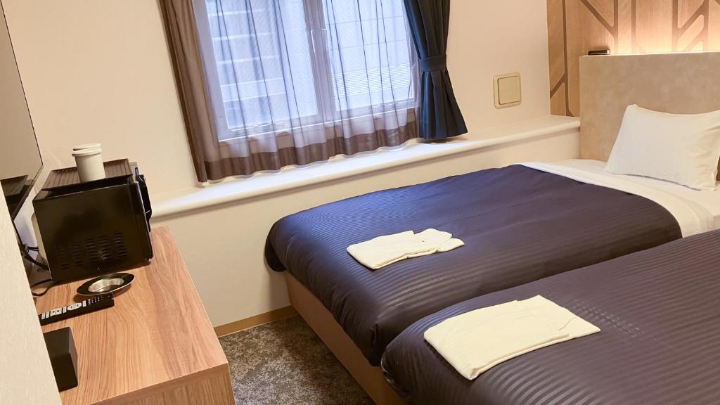 TV a/nebo společenská místnost v ubytování HOTEL LiVEMAX BUDGET Shinbashi