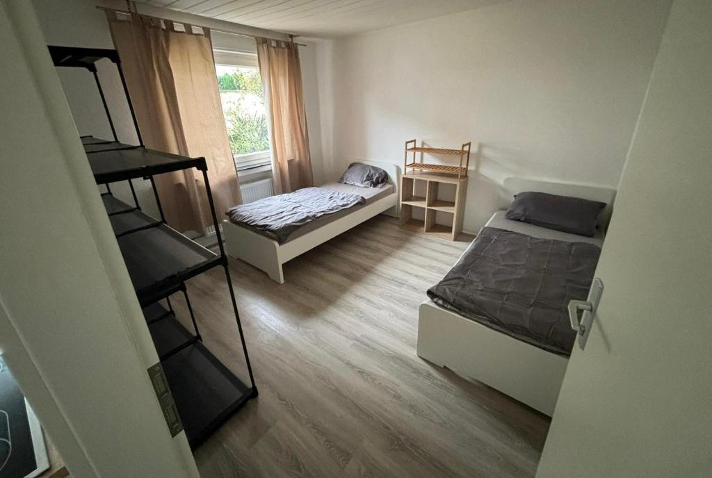 a small room with two beds and a window at SpeedStay - Duisburg Marxloh in Duisburg