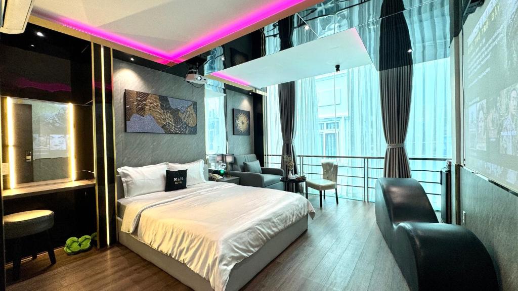 a bedroom with a bed with a purple lighting at M&H Hotel in Ho Chi Minh City