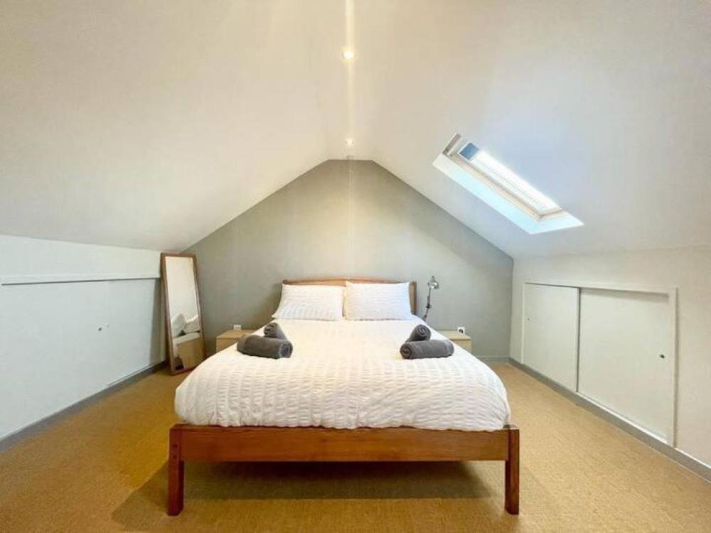 a bedroom with a large bed in a attic at Richmond House (9A) by Staytor Accommodation in Exeter