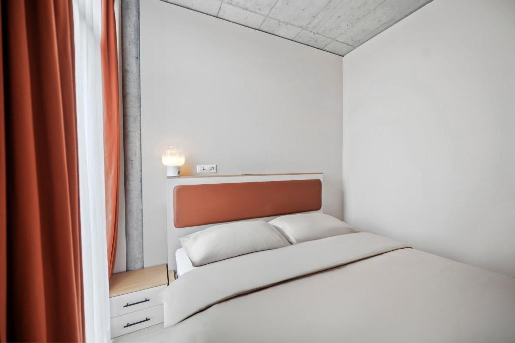 Ένα ή περισσότερα κρεβάτια σε δωμάτιο στο Ariv Design Hotel Zug