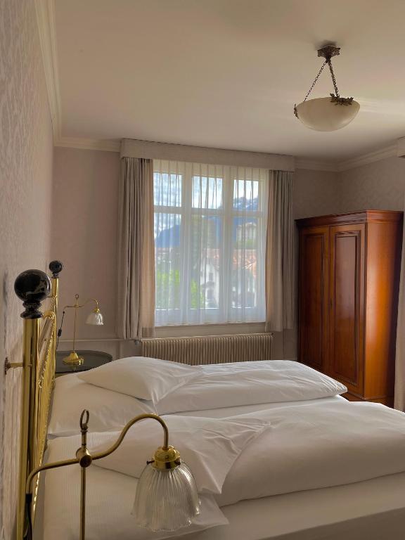Postel nebo postele na pokoji v ubytování Hotel De La Paix