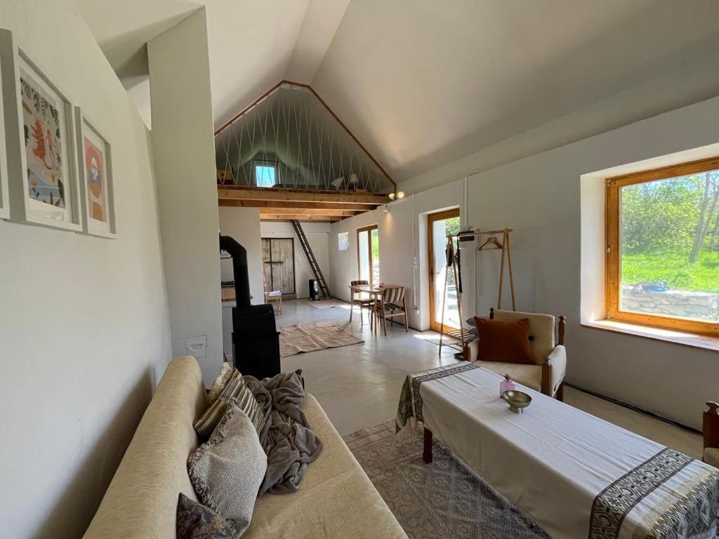 a living room with a couch and a table at Bazalt Tigris Vendégház in Zalahaláp