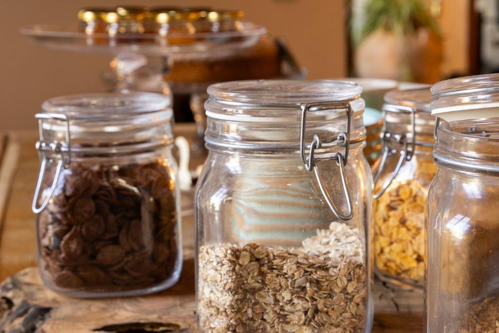 a group of glass jars filled with nuts and seeds at Ca's Xorc Luxury Retreat - ADULTS ONLY in Sóller