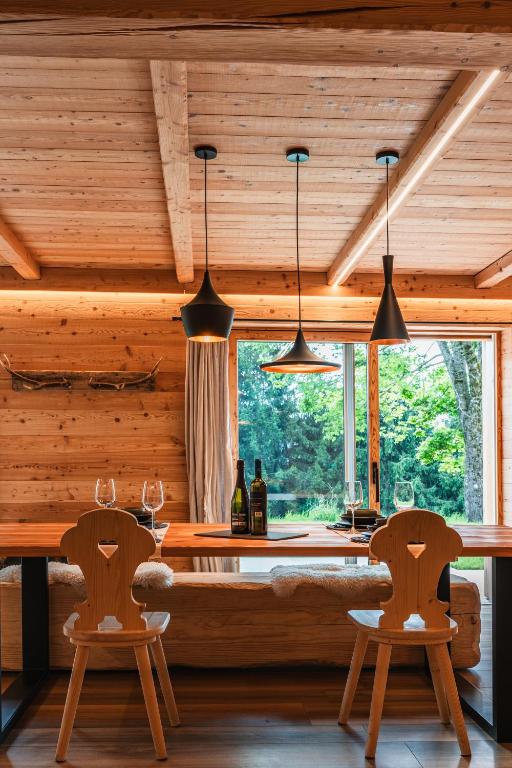 a dining room with a table and two chairs at Hideaway Chalet Porona in Ledro