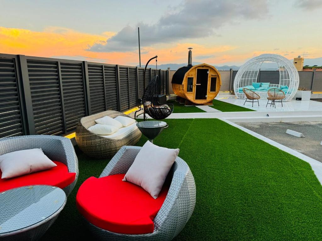 a patio with chairs and tables on a roof at Luxury Hills 1500ｍ2超絶景パティオ サウナ BBQ 駐車場4台 プール ペット 空港そば in Fukuoka