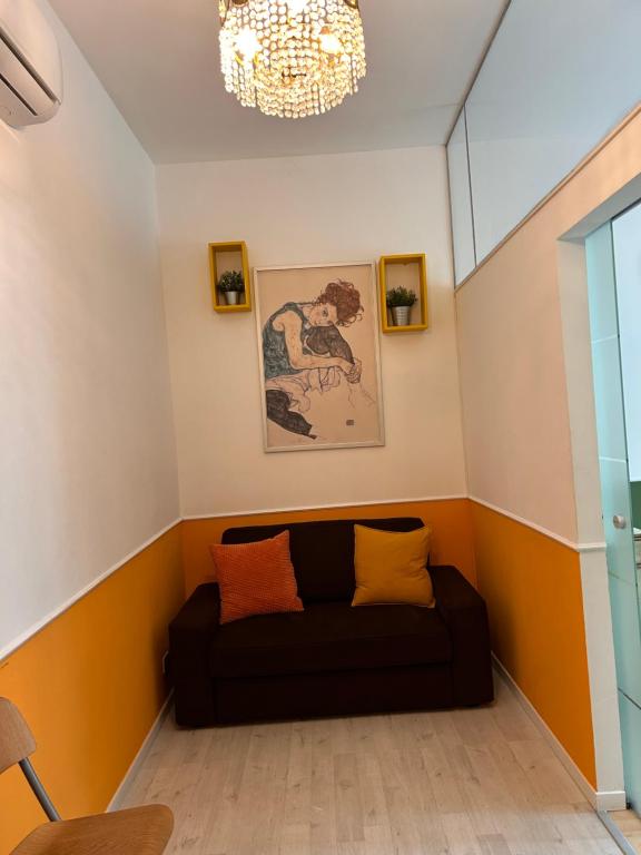 a living room with a couch in the corner at Claudia's Home in FieraCity&MiCo&SanSiro in Milan