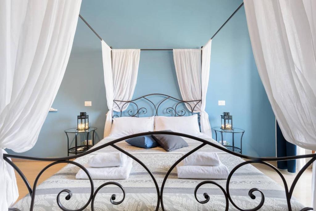 a bedroom with a bed with blue walls at Suite Laterani 3 bedrooms with parking in Rome