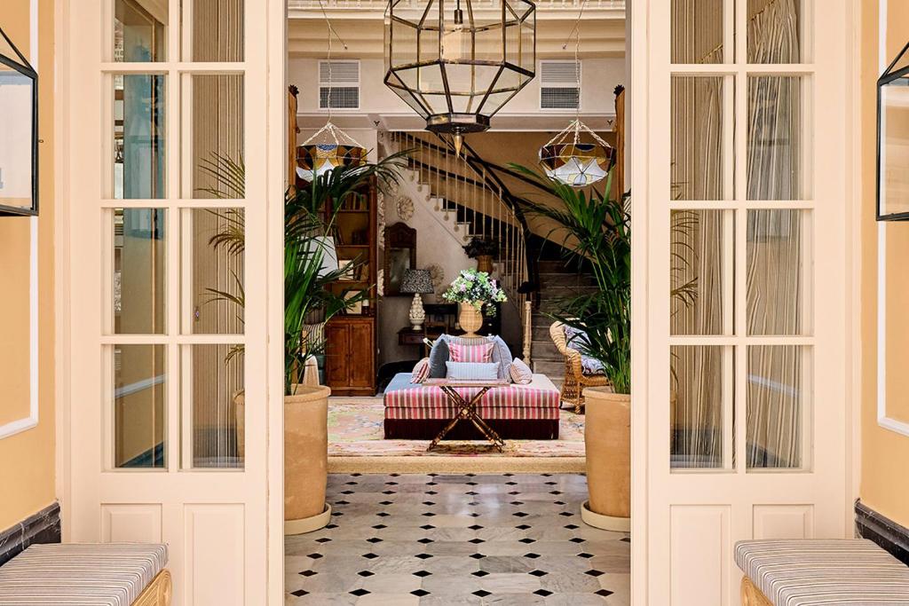 a living room with a couch and a table at Cristine Bedfor Malaga Boutique Hotel in Málaga