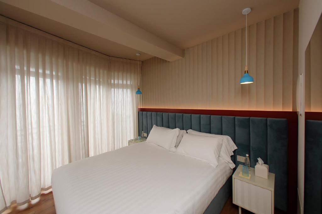 Postel nebo postele na pokoji v ubytování Hotel Unico by Dori
