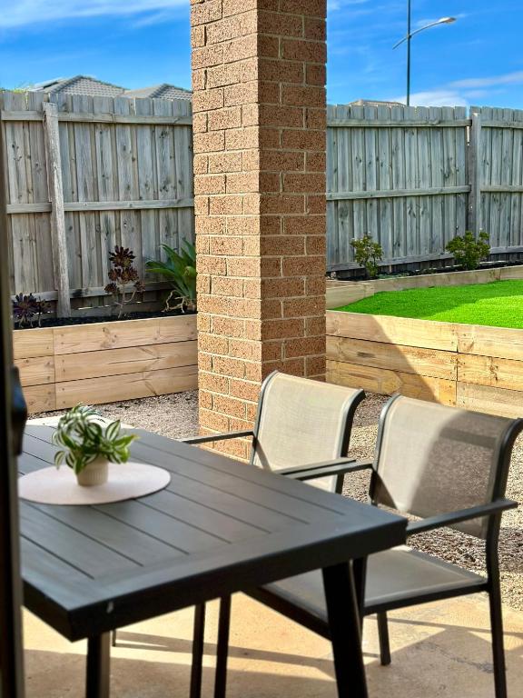 a black table and chairs on a patio at Valley View 4BR home near Food trucks and Station in Melton South