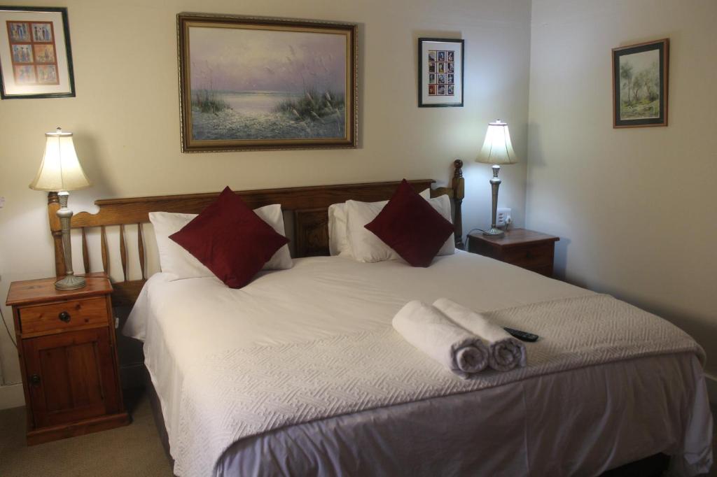 a bedroom with a bed with two towels on it at Umoya in Hilton
