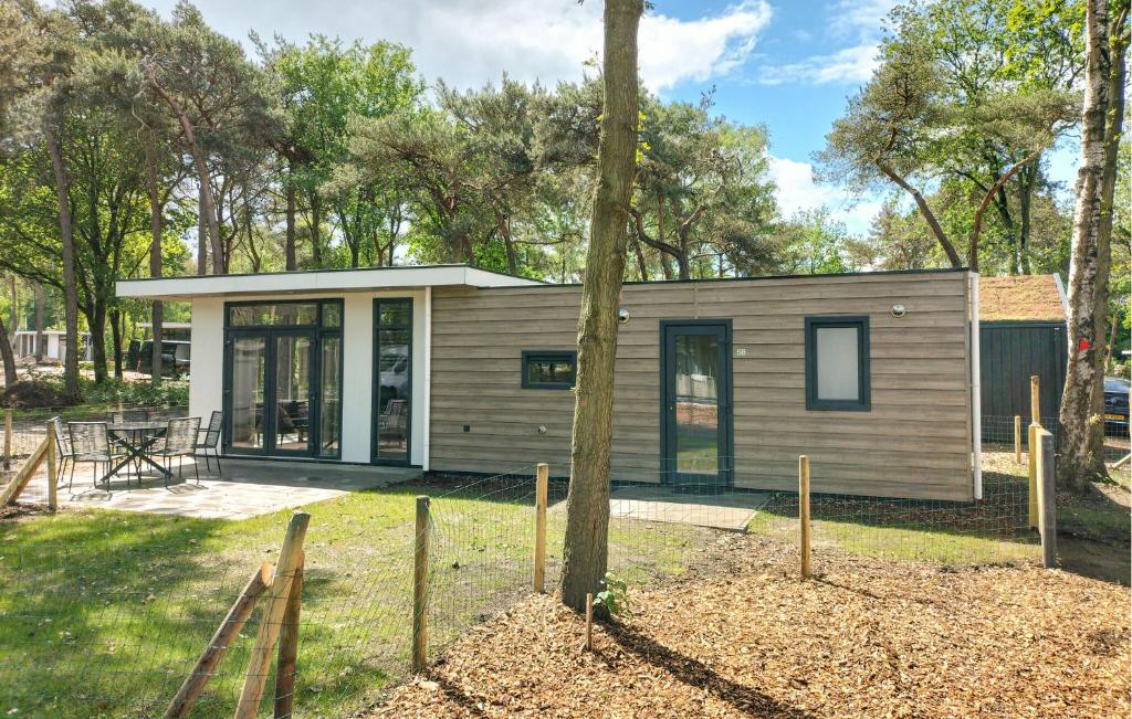 a tiny house in the woods with a tree at 2 Bedroom Amazing Home In Hellendoorn in Hellendoorn