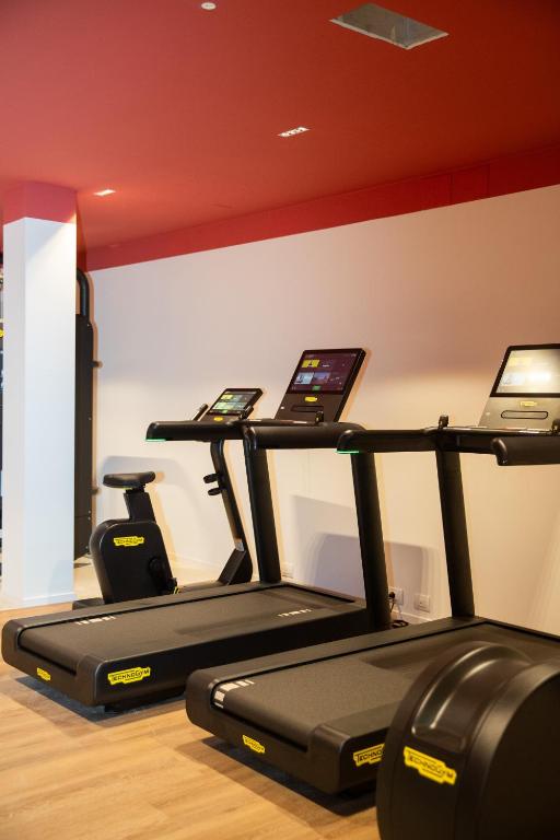 a gym with two tread machines in a room at Cala Ponte, a Tribute Portfolio Hotel in Polignano a Mare