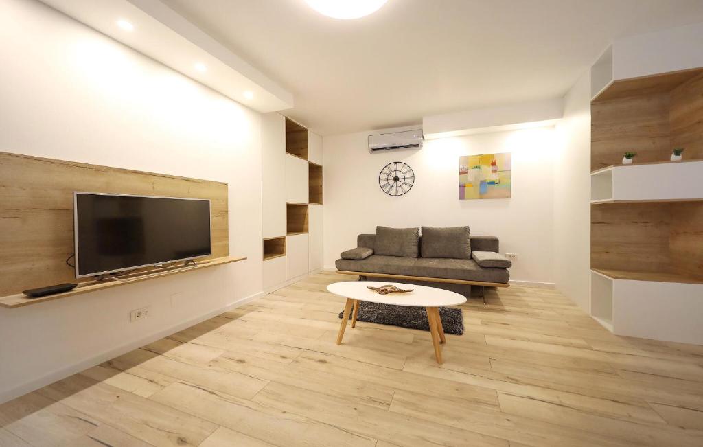 a living room with a couch and a tv at 2 Bedroom Lovely Apartment In Zadar in Zadar