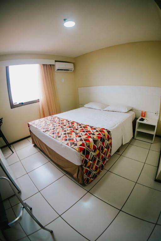 Postel nebo postele na pokoji v ubytování Soft Win Hotel São Luís