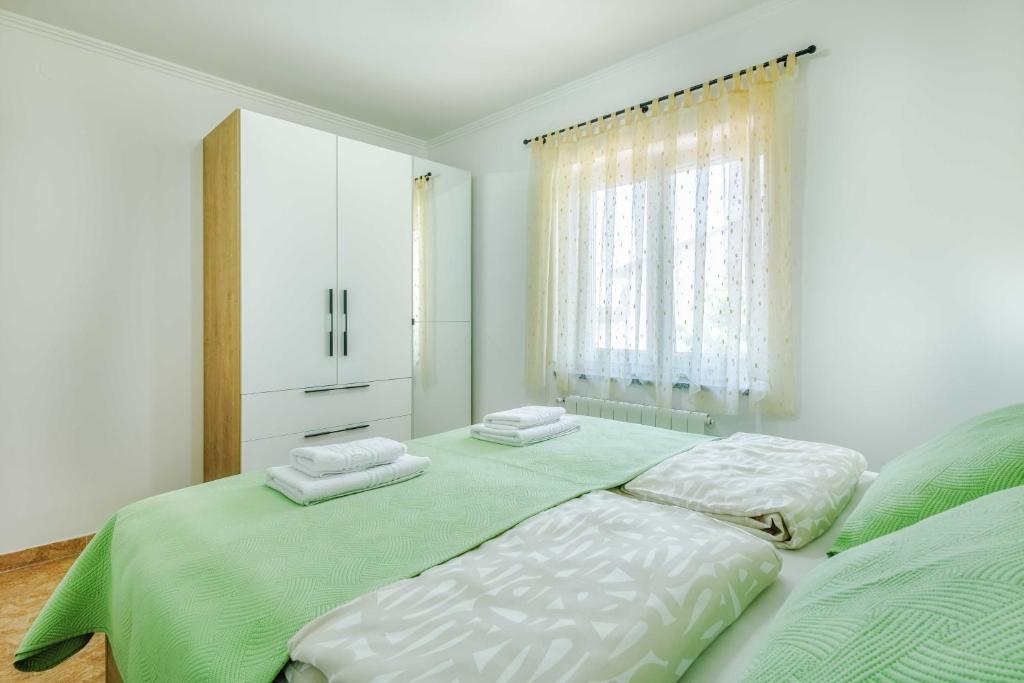Postel nebo postele na pokoji v ubytování Apartments Rose