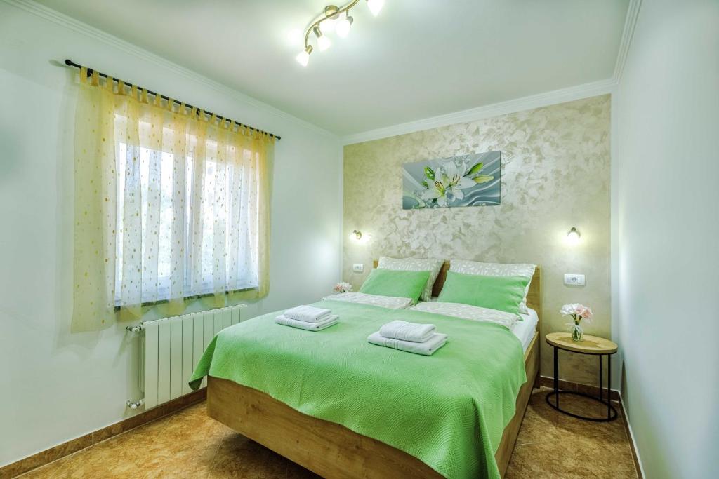Postel nebo postele na pokoji v ubytování Apartments Rose