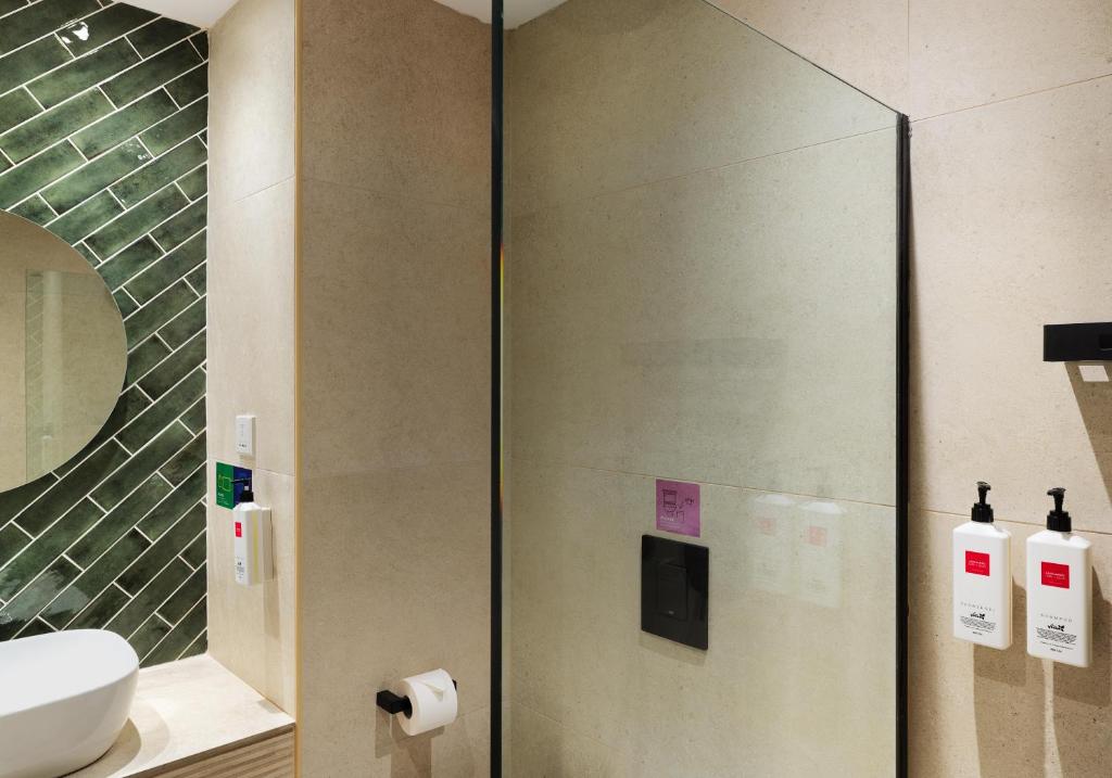 a bathroom with a shower with a toilet and a sink at Leonardo Cypria Bay in Paphos