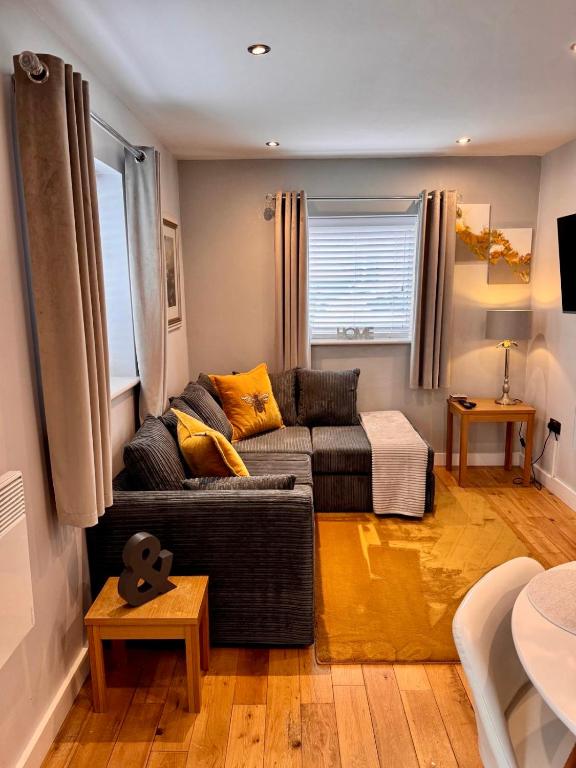 a living room with a couch and a table at Detached one bedroom house near to castle and cathedral in Lincoln