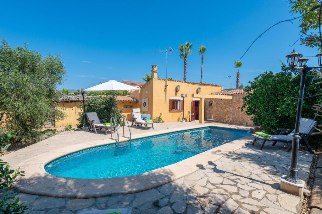 a swimming pool in front of a house at Raco De Can Pep in Inca