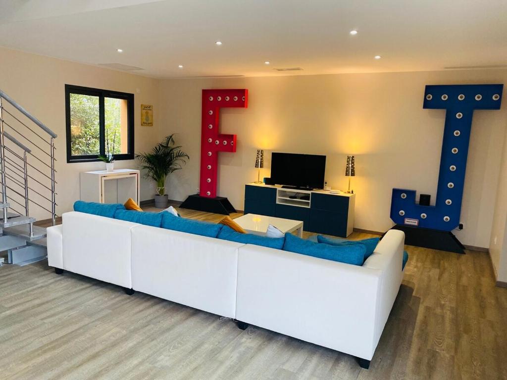 un salon avec un canapé blanc et une télévision dans l'établissement Villa VIE House in Grau d'Agde, au Grau-dʼAgde