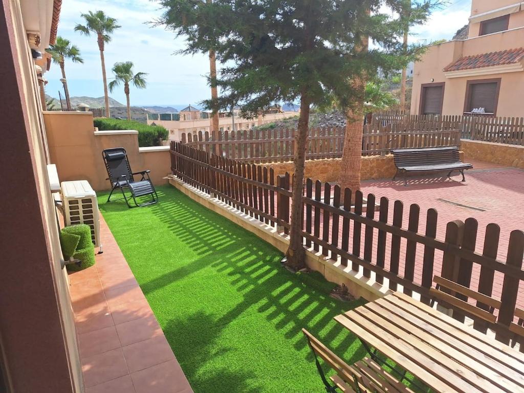 a yard with a fence and a bench and grass at Laurent's house - ATTC International Vacations in Isla del Fraile