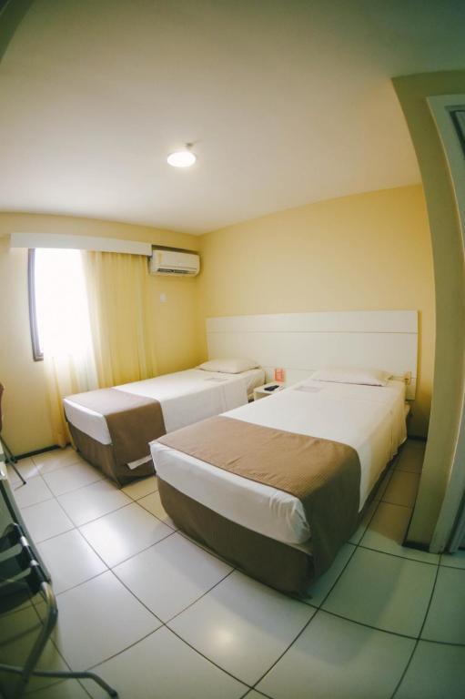 Postel nebo postele na pokoji v ubytování Soft Win Hotel São Luís