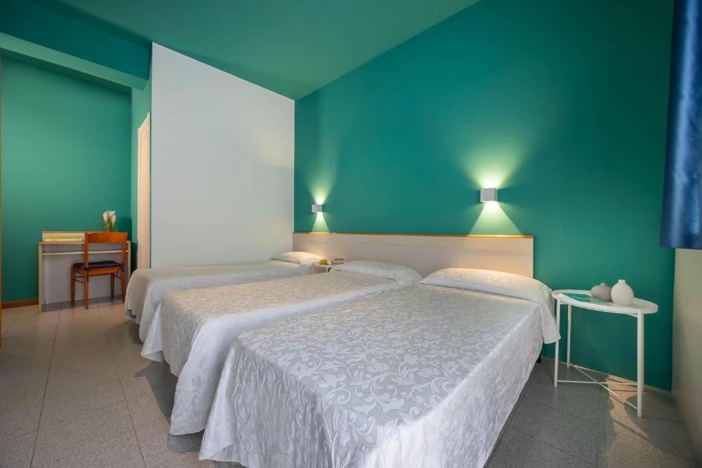 Postel nebo postele na pokoji v ubytování Hotel Portofino