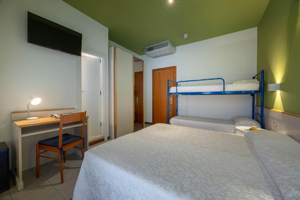 Postel nebo postele na pokoji v ubytování Hotel Portofino