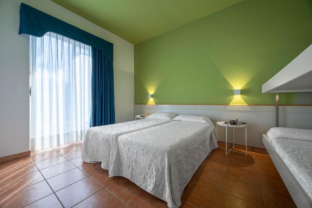 Postel nebo postele na pokoji v ubytování Hotel Portofino