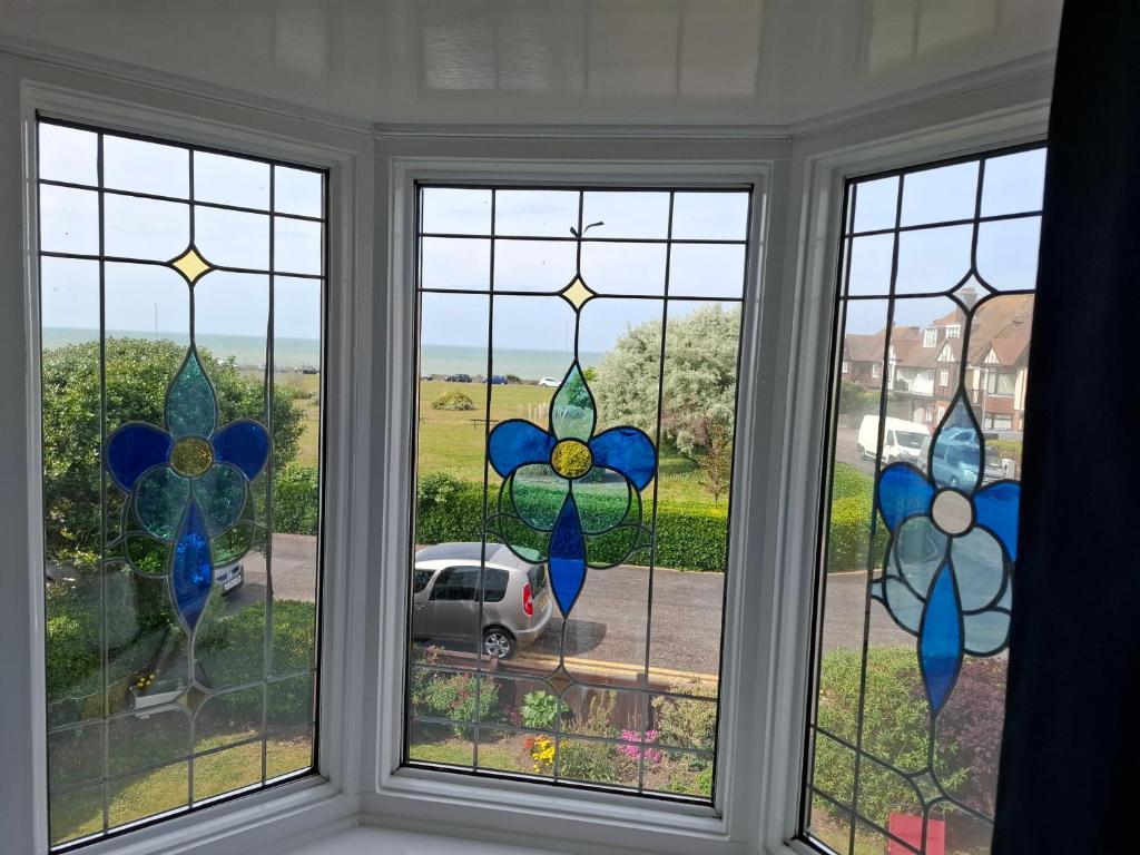 a window with four stained glass windows at Westbrook Lodge Guest House in Margate