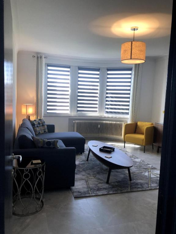 a living room with a couch and a table at Studio 30 Pied a terre in Brussels