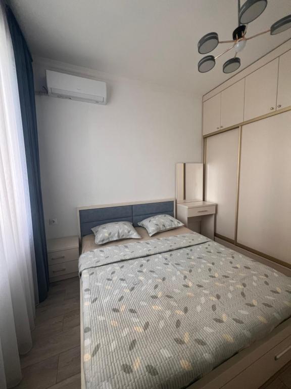 a bedroom with a large bed in a room at RINI Apartment in Muruntau