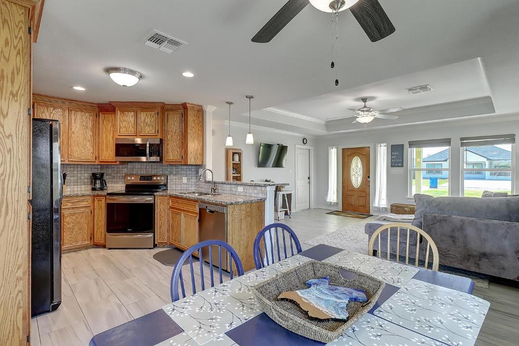 a kitchen and living room with a table and chairs at A Wave From It All in Rockport