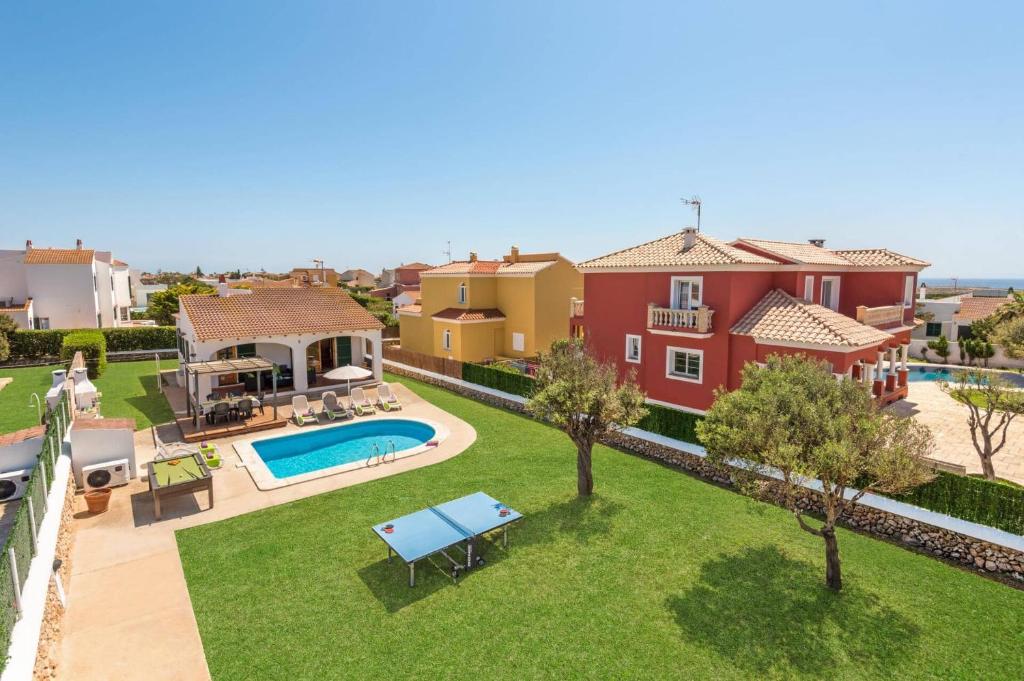 an aerial view of a house with a swimming pool at Villa Pomelo by Villa Plus in Cala en Blanes