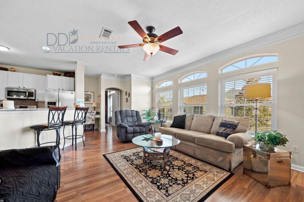 a living room with a couch and a ceiling fan at Legacy Villa 704 in Gulfport