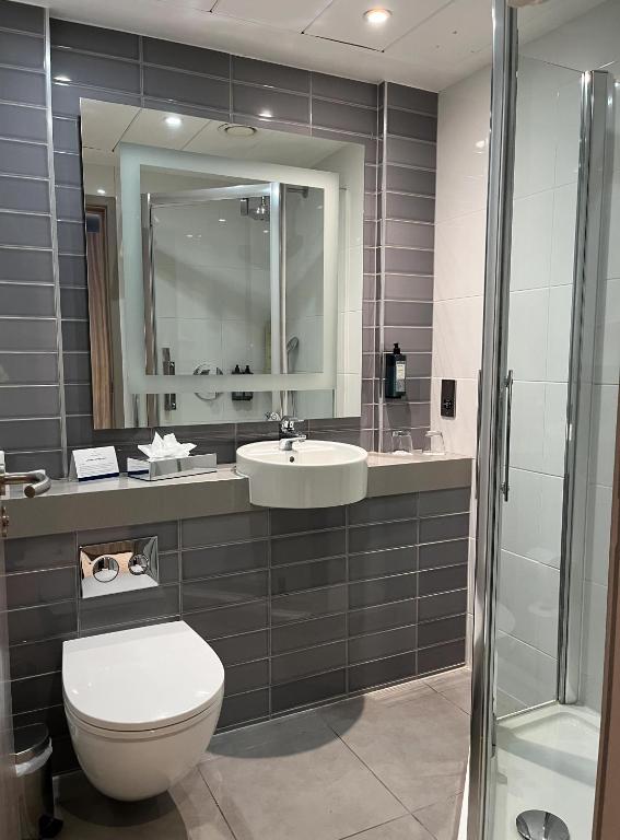 a bathroom with a toilet and a sink and a shower at Whites of Wexford in Wexford