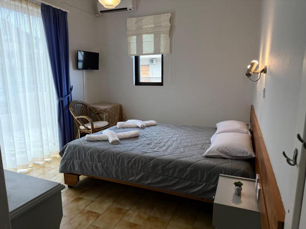 a bedroom with a bed with two towels on it at Villa Konstantina in Tolo