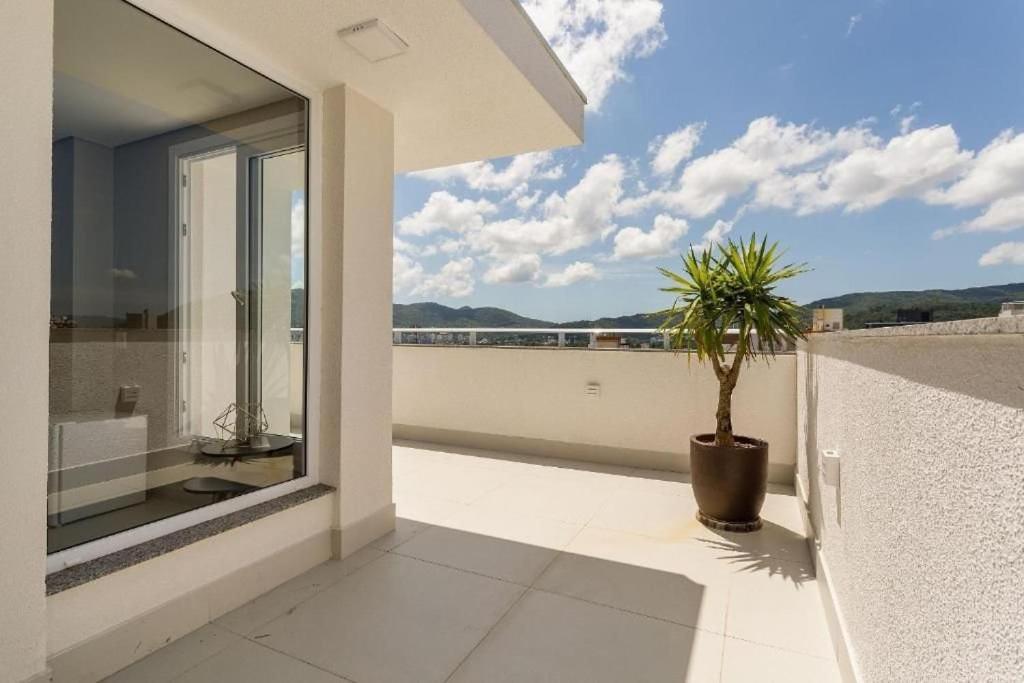 a balcony with a potted plant and a view at SPA - Studios incríveis em Floripa-SC in Florianópolis