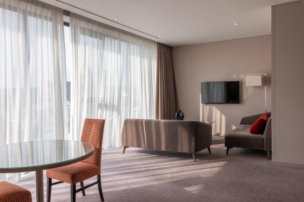 a hotel room with a table and chairs and a couch at Whites of Wexford in Wexford