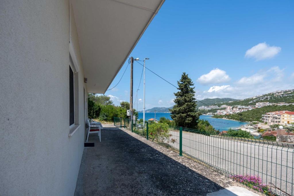 a balcony of a building with a view of the water at Holiday Home Casa Blu near the Beach in Neum
