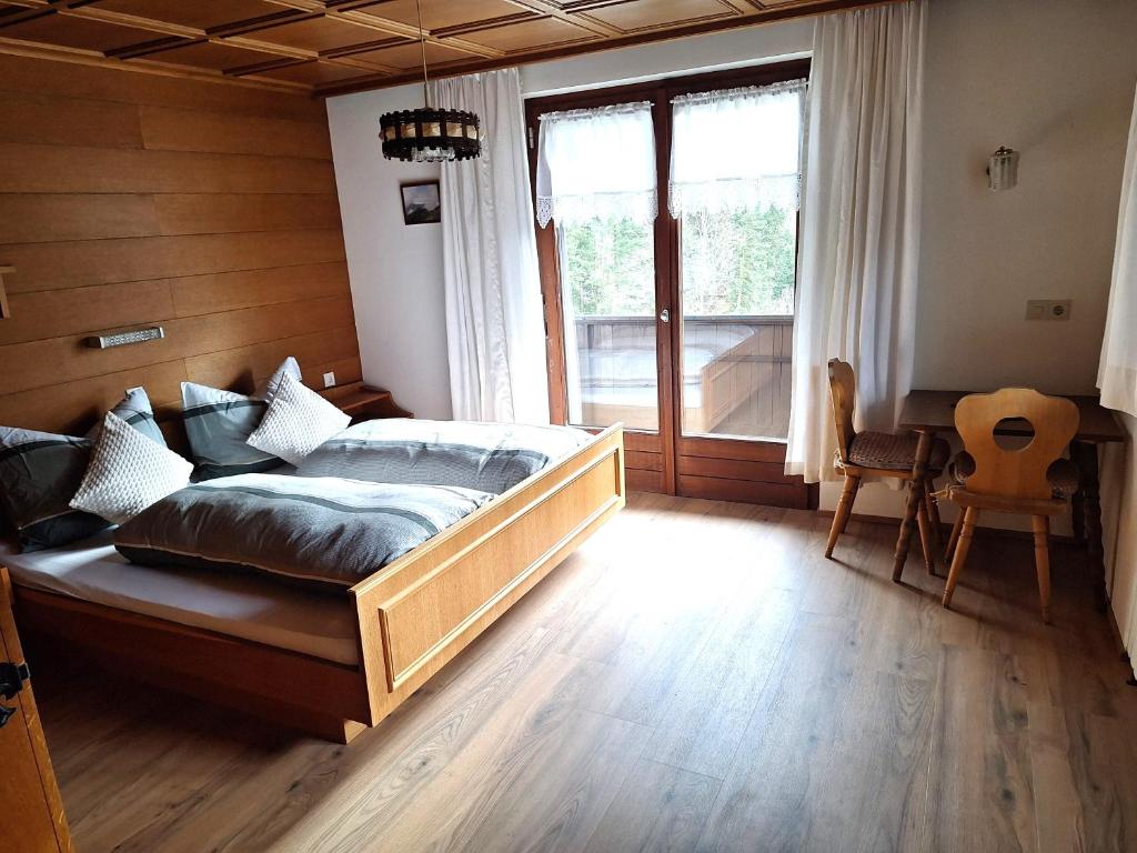 a bedroom with a bed and a large window at Ferienwohnung Rüf in Bizau