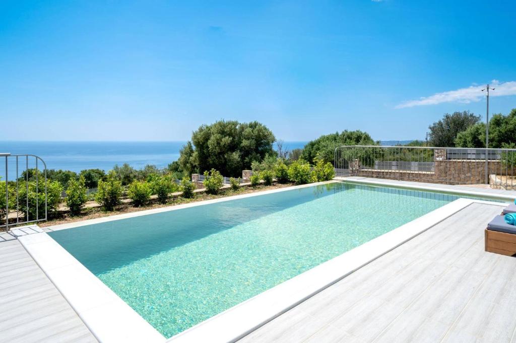 a swimming pool in a villa with a view at Villa Prasino by Villa Plus in Plateies