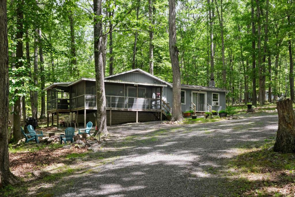a house in the middle of the forest at Dog-Friendly w Hot Tub, Fire Pit & River Access in Great Cacapon