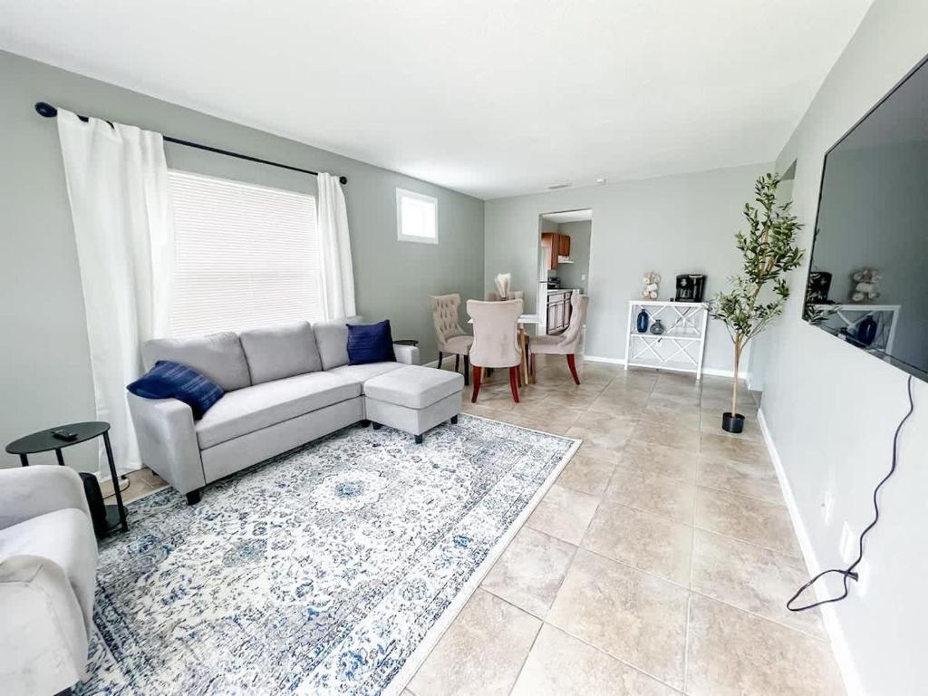a living room with a couch and a table at Cozy 2 Bedroom home, Dade City! in Dade City