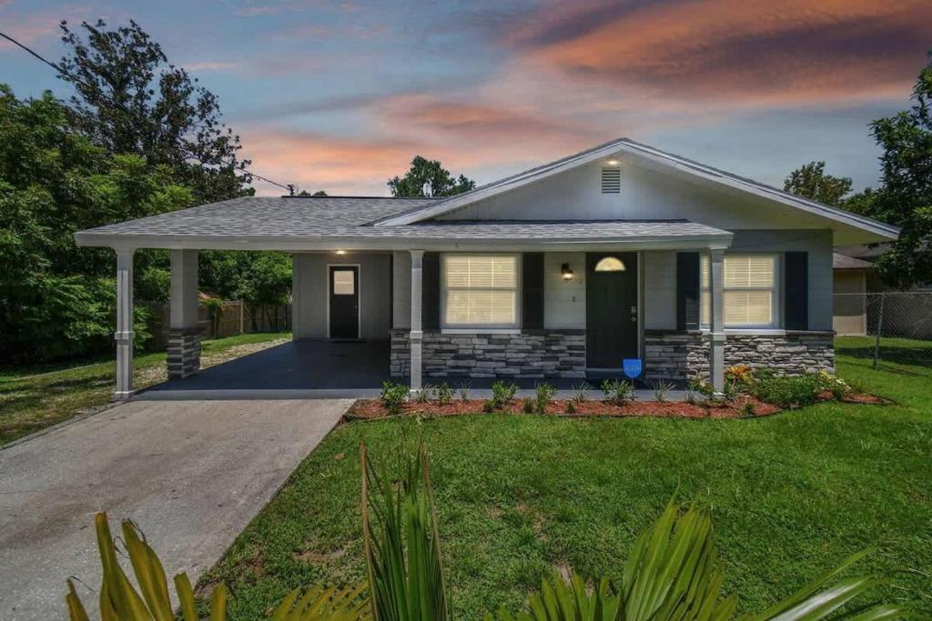 a house with a driveway in a yard at Comfortable Home in Dade City! in Dade City