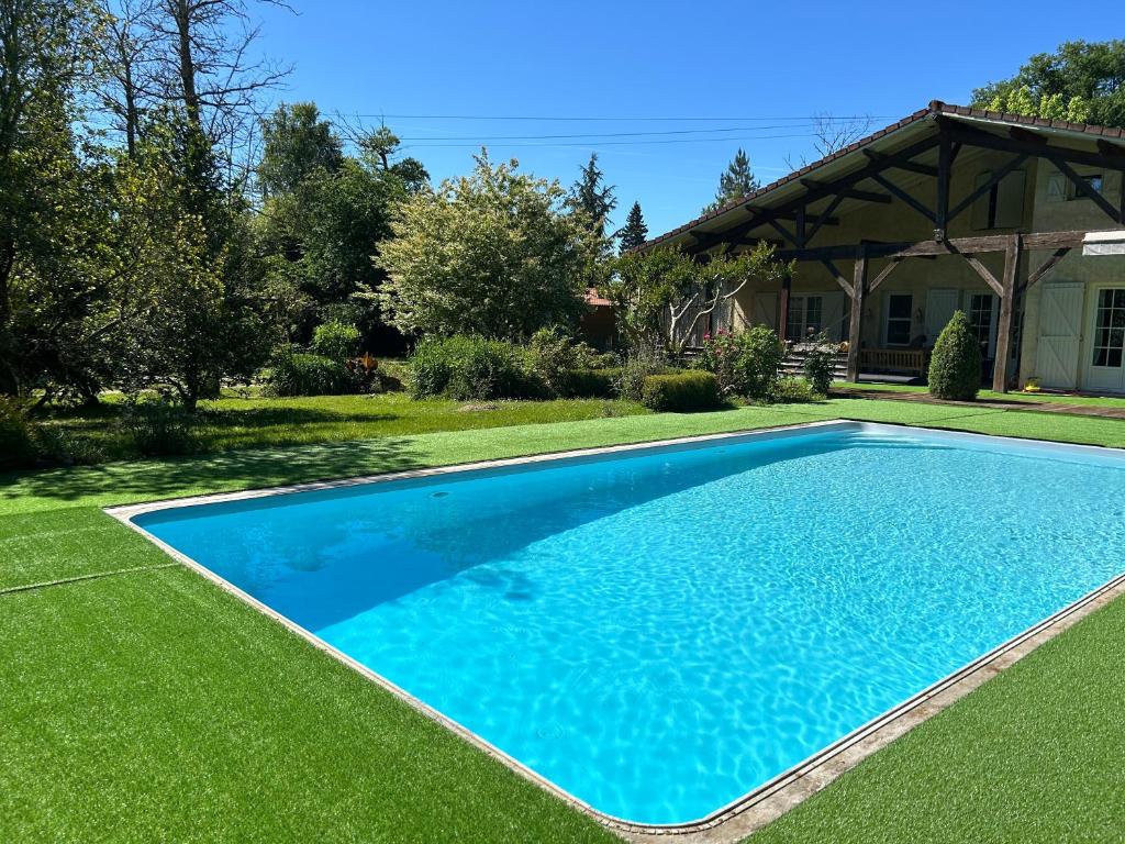 a swimming pool in a yard with green grass at Maison de vacances Bazas in Lignan-de-Bazas