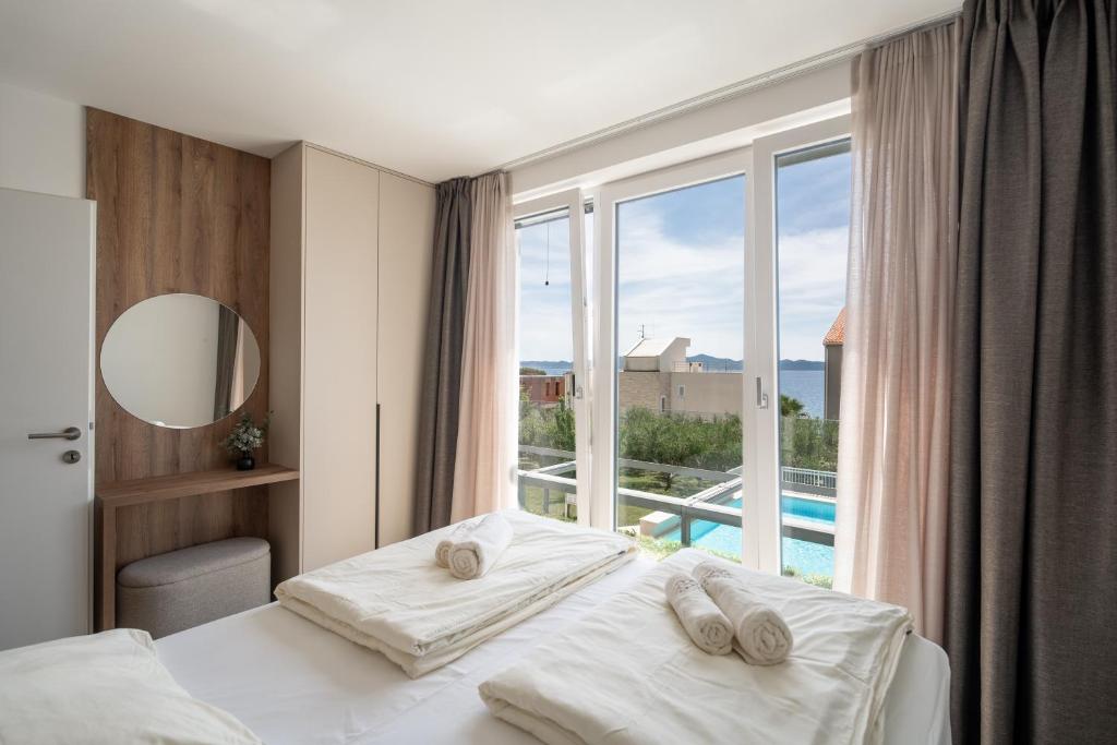Posteľ alebo postele v izbe v ubytovaní SunAdria Apartments