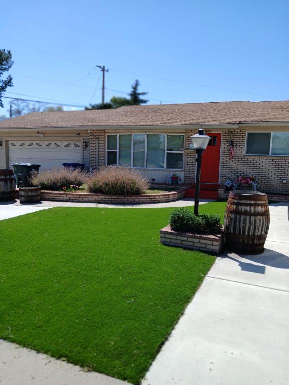 a house with a yard with a green lawn at Home sweet Home West in West Valley City